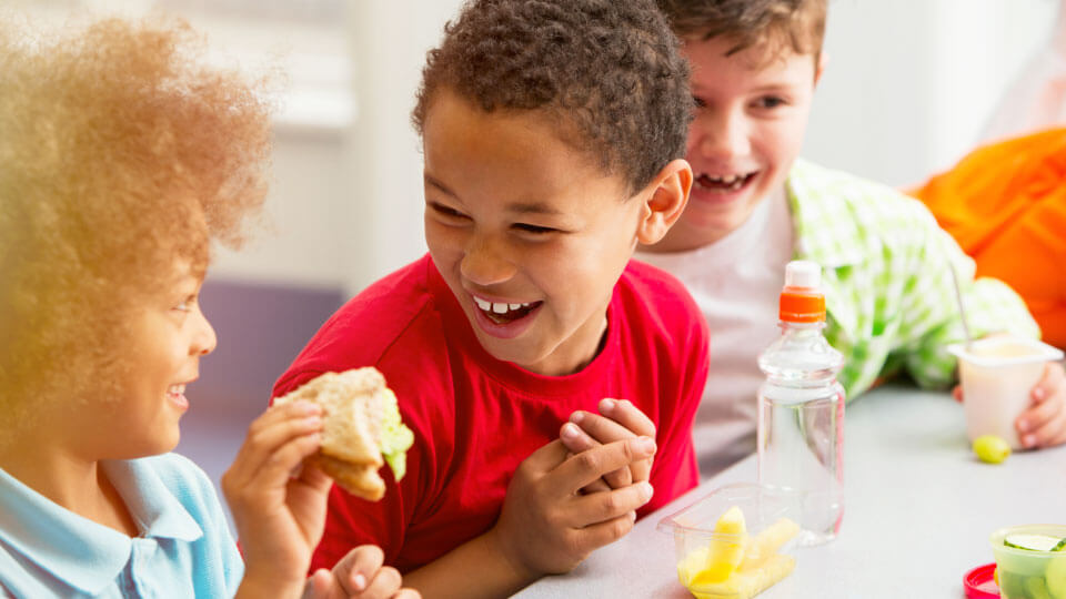 Kids in a school cafeteria at lunch - Foster Farms